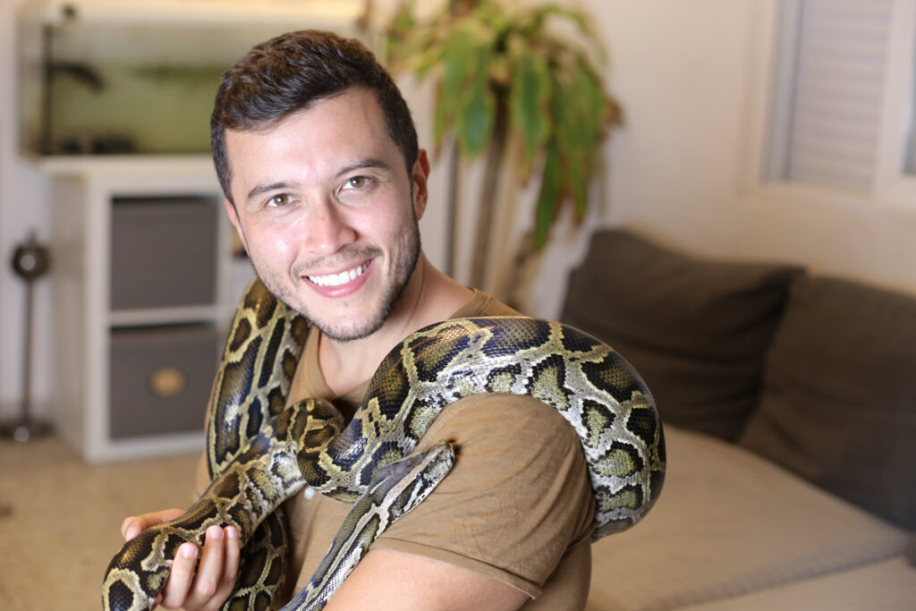 Man with beautiful pet snake